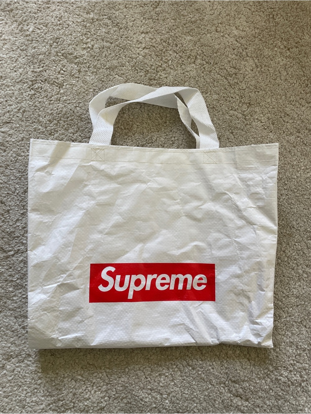 white woven Supreme reusable shopping tote bag